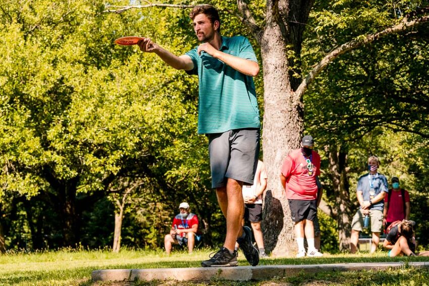 Professional disc golfer showing how to throw a distance driver